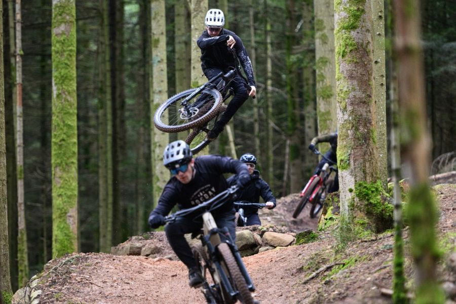 e-MTB riders riding through woods